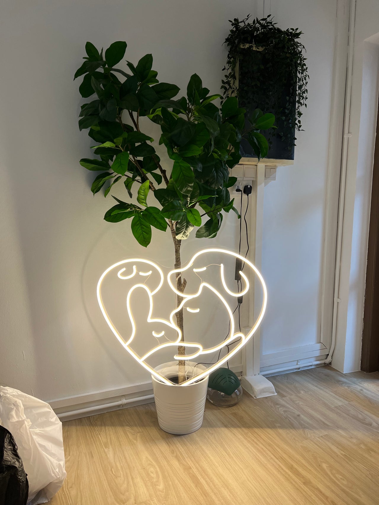 The Grooming Angels neon sign — warm salon interior